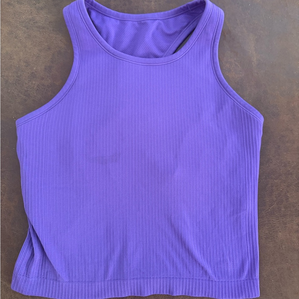 Three workout tops.  Purple, royal blue, sage green
